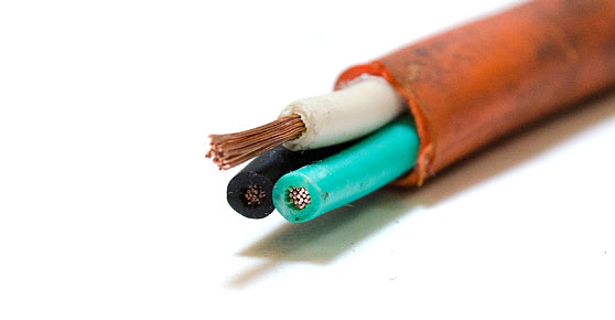 Insulated Copper Wire - Detailed view of a pair of copper wires, one orange and one green