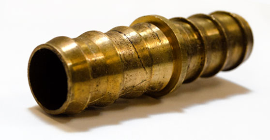 Yellow Brass - Shiny yellow brass pipe connector on white background